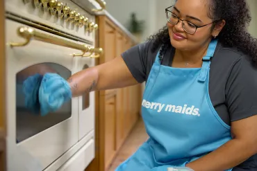 merry maid cleaning a stove